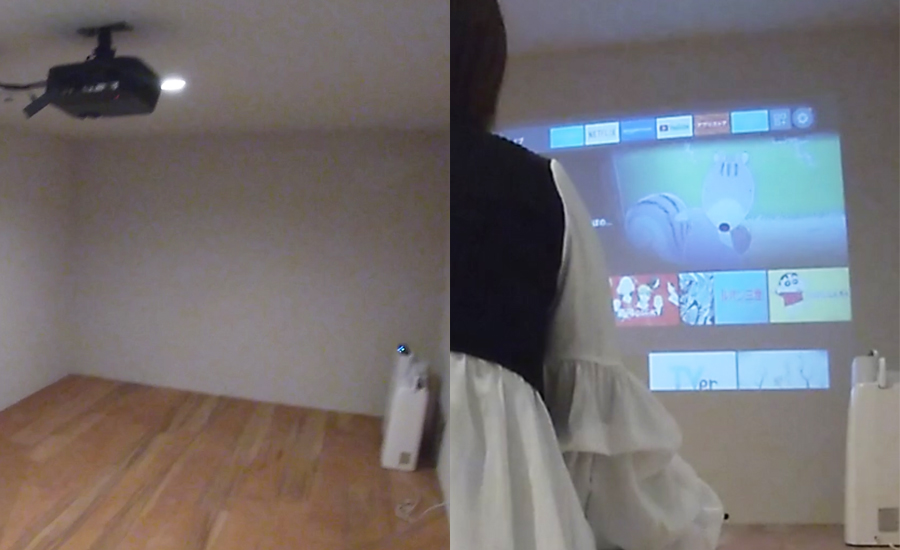 寝室には大きく壁に移せるプロジェクターが設備されている